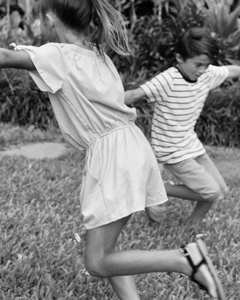 Boy and girl play on lawn